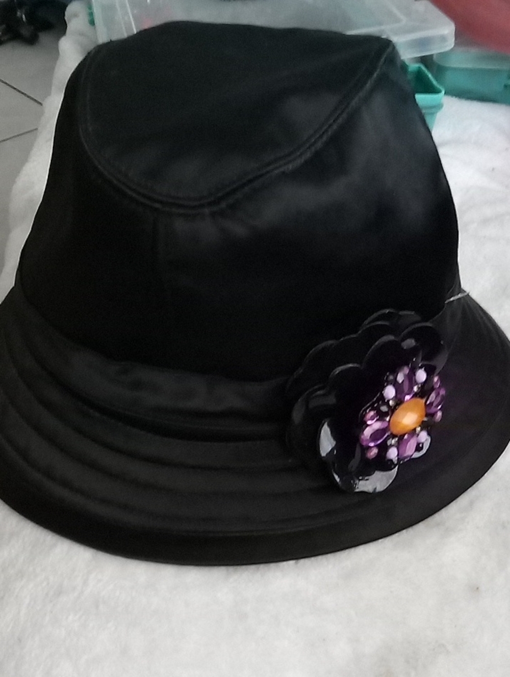 Jennifer Lopez Black Satin Bucket Hat with Flower Accent, Purple Brooch